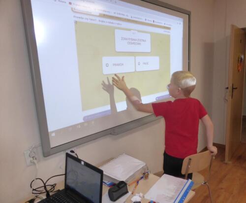 chłopiec rozwiązuje quiz na tablicy interaktywnej