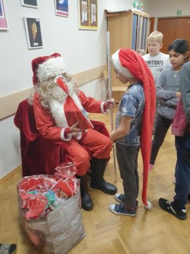 Mikołaj przekazuje paczkę wychowankowi