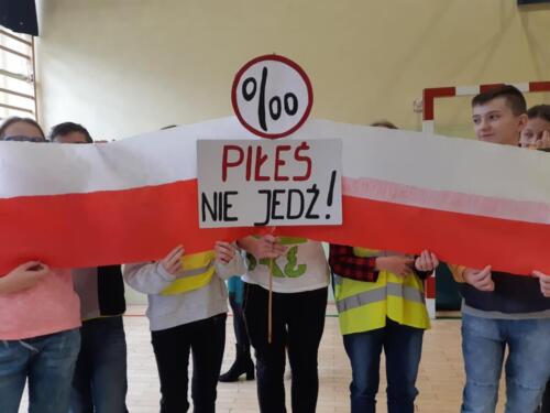 Zdjęcie dzieci z flagą Polski i transparentem z napisem "Piłeś - nie jedź"