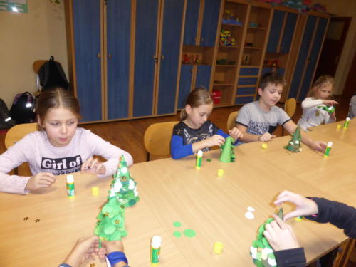 Dzieci robią przestrzenne choinki z kółek z papieru